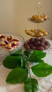 a table with two plates of pastries and green leaves at B&B Casa CamiLory in San Lucido