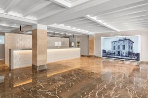 a large room with a picture of a building at Hotel Castell dels Hams in Porto Cristo