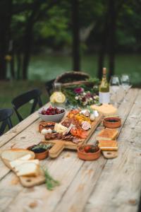 a wooden table with a bunch of food on it at Kami The Essence in Danilovgrad