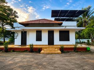a house with solar panels on the roof at Nature Heritage by Marari in Mararikulam