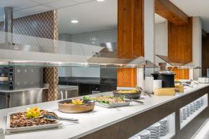 a kitchen with many plates of food on a counter at ALEGRIA Maripins in Malgrat de Mar