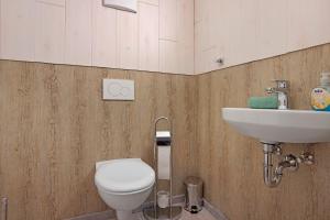 a bathroom with a toilet and a sink at Ferienwohnung Schaule in Bolsterlang +14 photos