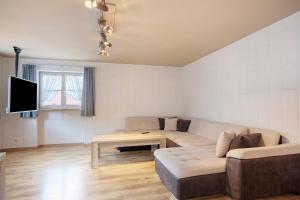a living room with a couch and a table at Ferienwohnung Schaule in Bolsterlang