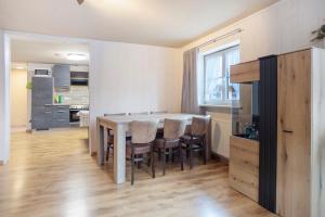 a kitchen with a table and chairs in a room at Ferienwohnung Schaule in Bolsterlang
