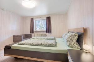 a bedroom with a bed and a window at Ferienwohnung Schaule in Bolsterlang