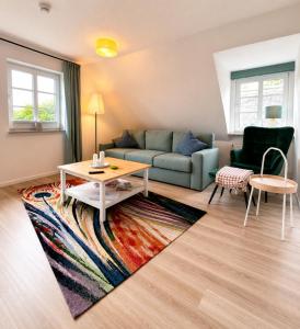 a living room with a couch and a table at Inselglück Föhr in Wrixum