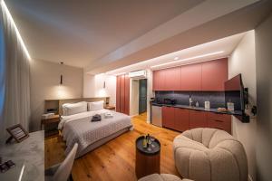 a hotel room with a bed and a kitchen at Sky Suites Nicosia in Strovolos