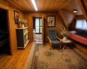 a living room with a couch and a chair at Magiczny Dom nad Bugiem in Pętkowo Wielkie