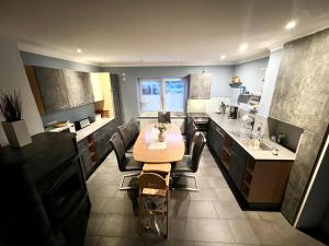 a kitchen with a table and chairs in it at Haus Rosenwind in Wangerland