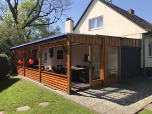 an extension to a house with sliding glass doors at Haus Rosenwind in Wangerland
