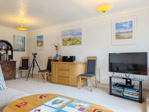 a living room with a television and a desk at 2 Seafield Terrace, Bognor Regis in Bognor Regis