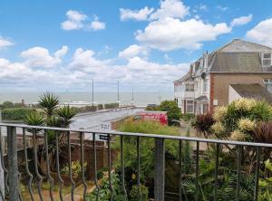 a view of the beach from the balcony of a house at 2 Seafield Terrace, Bognor Regis in Bognor Regis