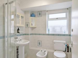 a bathroom with a toilet and a sink and a window at 2 Seafield Terrace, Bognor Regis in Bognor Regis +23 photos
