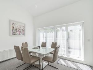 a dining room with a table and chairs and a window at High Trees View in Knaresborough
