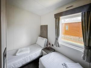 a small room with two beds and a window at Phoenix - Uk49470 in Morpeth