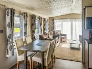 a dining room with a table and a couch at Phoenix - Uk49470 in Morpeth