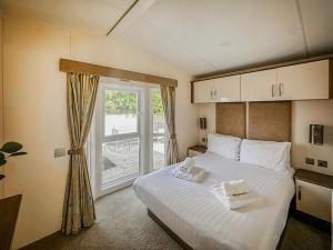 a bedroom with a bed and a large window at Phoenix - Uk49470 in Morpeth