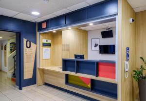 an office with blue walls and a reception desk at B&B HOTEL FREJUS Puget-sur-Argens in Fréjus +23 photos