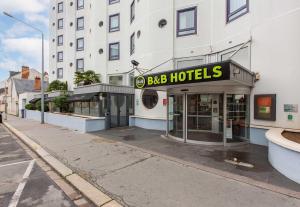a building with a bbb hotels sign on a street at B&B HOTEL Orléans Centre Foch in Orléans +23 photos