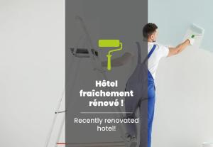 a man painting a wall with a brush at B&B HOTEL Orléans Centre Foch in Orléans