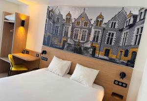a hotel room with a bed and a painting on the wall at B&B HOTEL Orléans Centre Foch in Orléans