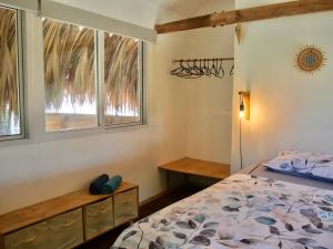 a bedroom with a bed and a window at Santa Lova Eco-hostel Isla Tintipan in Tintipan Island