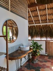 a bathroom with a sink and a mirror at Santa Lova Eco-hostel Isla Tintipan in Tintipan Island