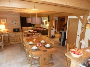 a kitchen and living room with a table and chairs at Chalet Le Solaret in Megève