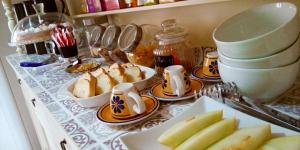 a counter topped with plates of food on a table at Il Sole del Mediterraneo in Noto +70 photos