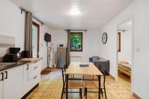 a kitchen and dining room with a table and chairs at 1.Chataigniers option clim- 4pers in Calviac