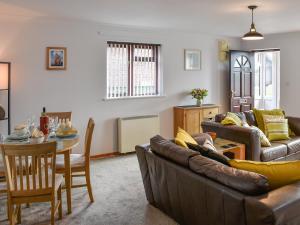 a living room with a couch and a table at Turnstones in Walcott