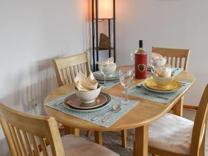 a wooden table with plates and wine glasses on it at Turnstones in Walcott