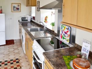 a kitchen with a sink and a counter top at Beuchan Cottage Keir Mill in Closeburn