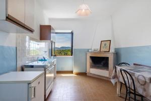 a kitchen with a table and a fireplace in it at Le Vallocchie in Concerviano