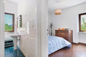 a bedroom with a bed and a sink and a window at Le Vallocchie in Concerviano