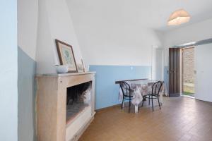 a living room with a fireplace and a table at Le Vallocchie in Concerviano +20 photos