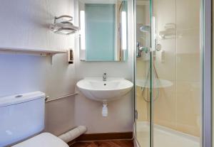 a bathroom with a toilet and a sink and a shower at B&B HOTEL Chalon-Sur-Saone Sud in Saint-Rémy