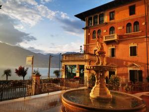 a water fountain in front of a building at Garda Family House in Brenzone sul Garda