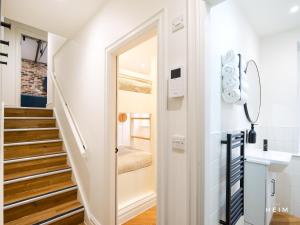 a hallway with a door leading up to a stairway at The Heim Aparthotel in Manchester +287 photos