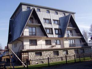 a building with a gambrel roof on top of it at Willa Cachro in Zakopane