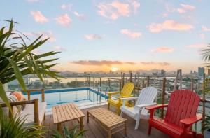 a balcony with colorful chairs and a swimming pool at Santori Hotel And Spa in Danang