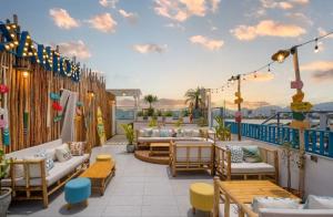 a patio with couches and tables on a balcony at Santori Hotel And Spa in Danang