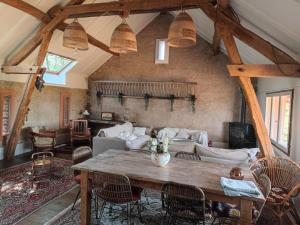 a living room with a table and a couch at Le maison sour les ailes in Cossaye