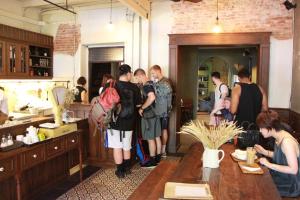 a group of people standing in a kitchen at Niras Bankoc Hostel in Bangkok