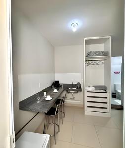 a kitchen with a table and chairs in a room at Studio #3 Rubi in Campos dos Goytacazes