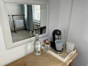 a mirror sitting on a wooden shelf in a room at Poplars Farm in Henlow