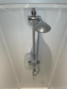 a light in the corner of a bathroom with a sink at Poplars Farm in Henlow +85 photos