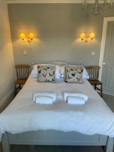 a large white bed with two pillows on it at Poplars Farm in Henlow