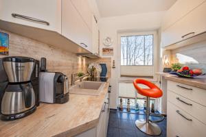 a kitchen with a coffee maker and a sink at Seeblick Leuchtturm in Koserow