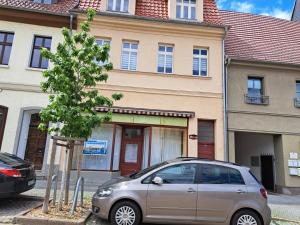 a silver car parked in front of a building at NEU! Fewo Calbe an der Saale in Calbe